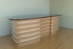 Art Deco themed ribbed desk. Wood, stainless and glass materials.